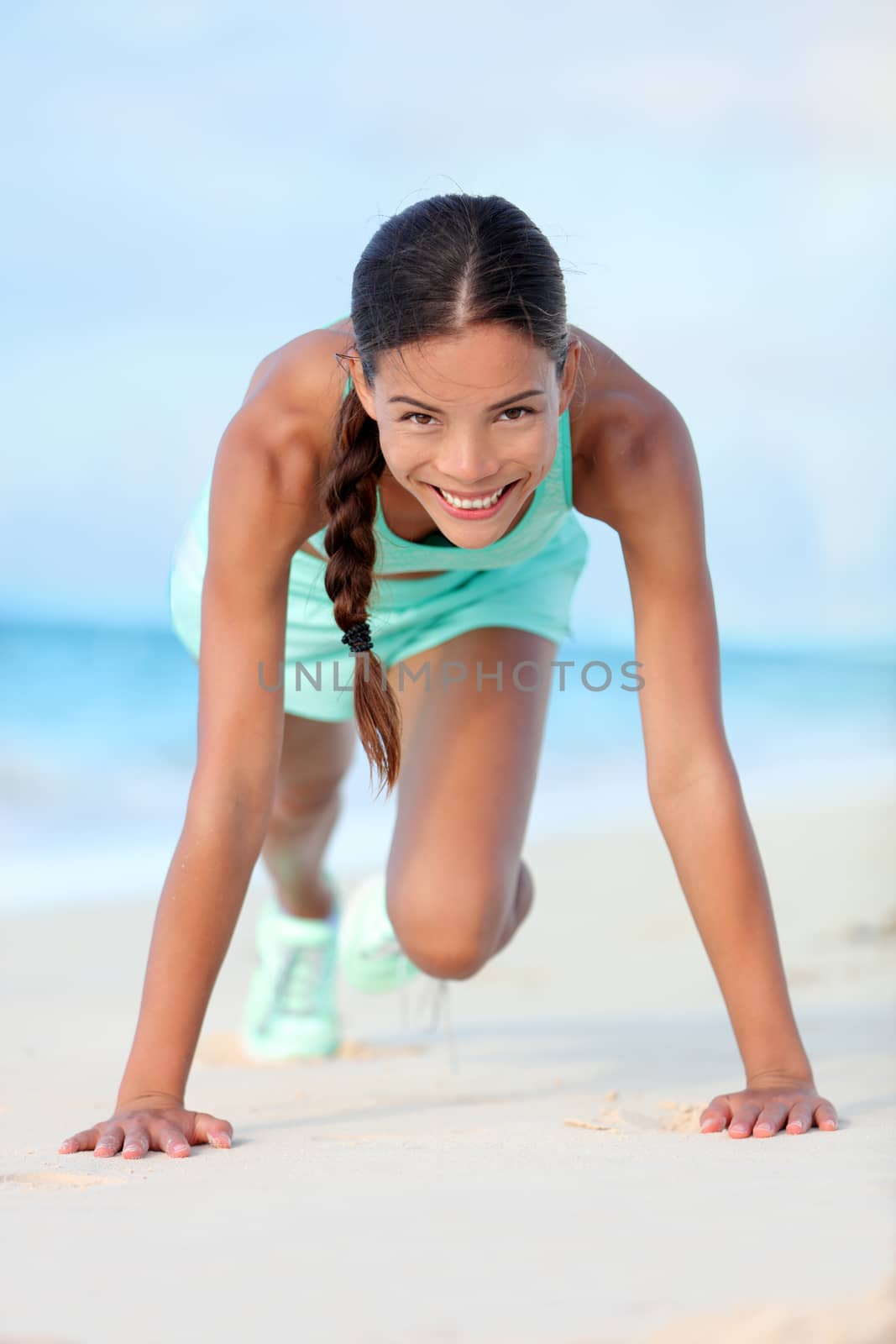 Fitness girl training core abs doing mountain climber workout exercises on beach by Maridav