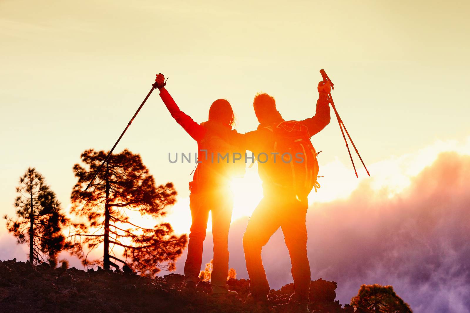 Hiking Couple Happy By Mountain Sunset In Success by Maridav