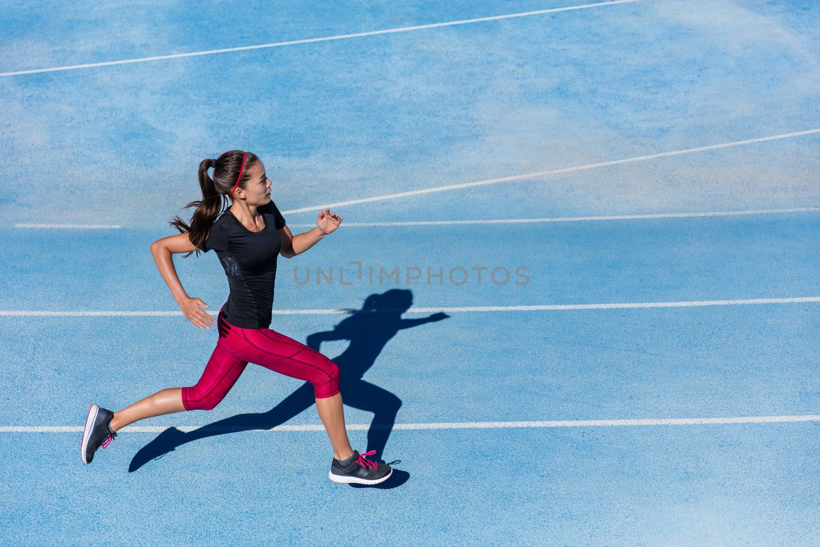 Athlete runner woman running on athletic run track by Maridav