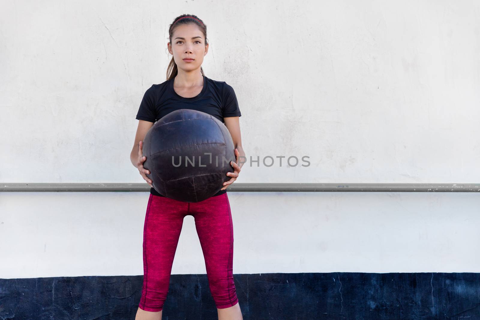Fitness gym woman training arms with medicine ball by Maridav