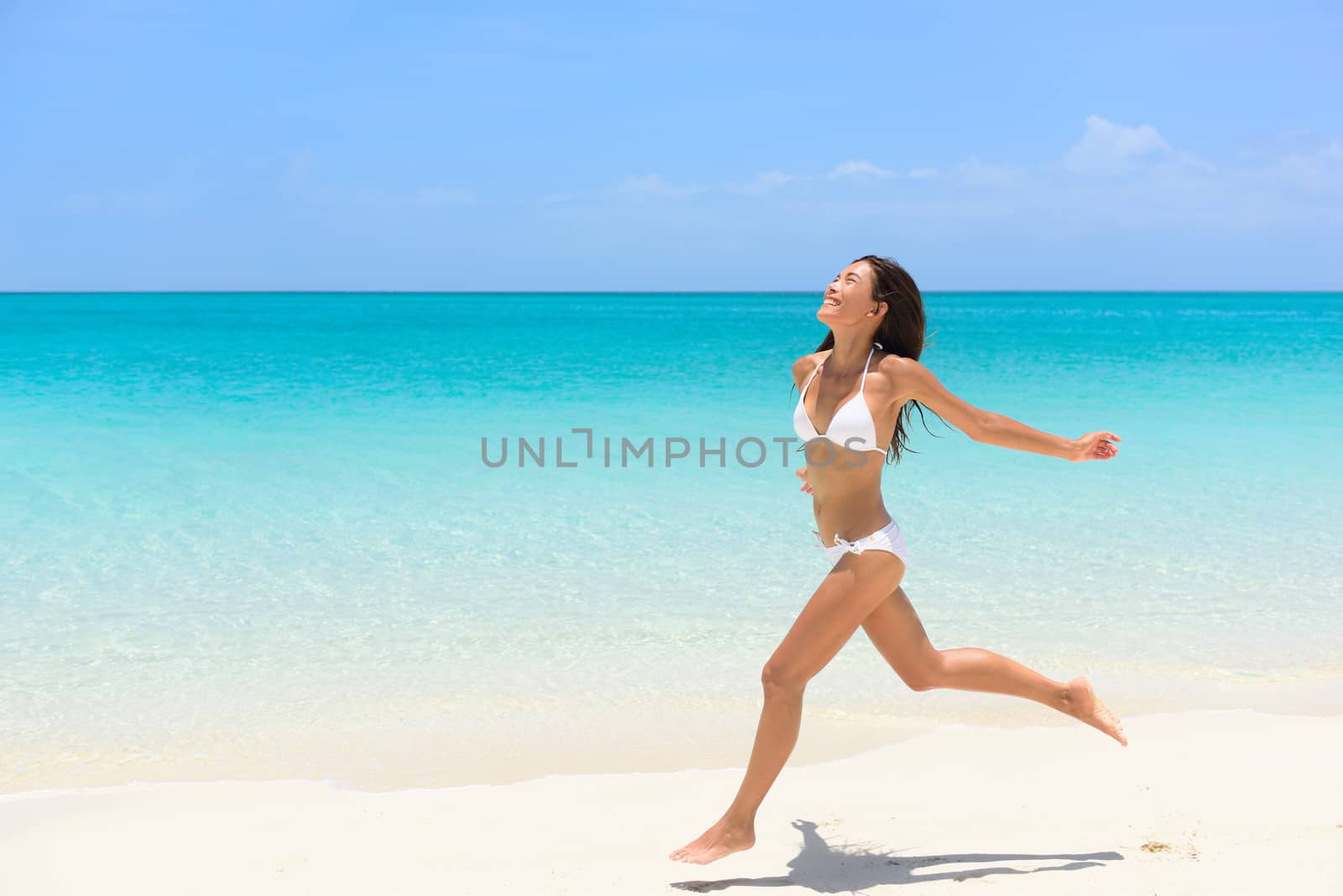 Beach bikini woman carefree running in freedom fun by Maridav