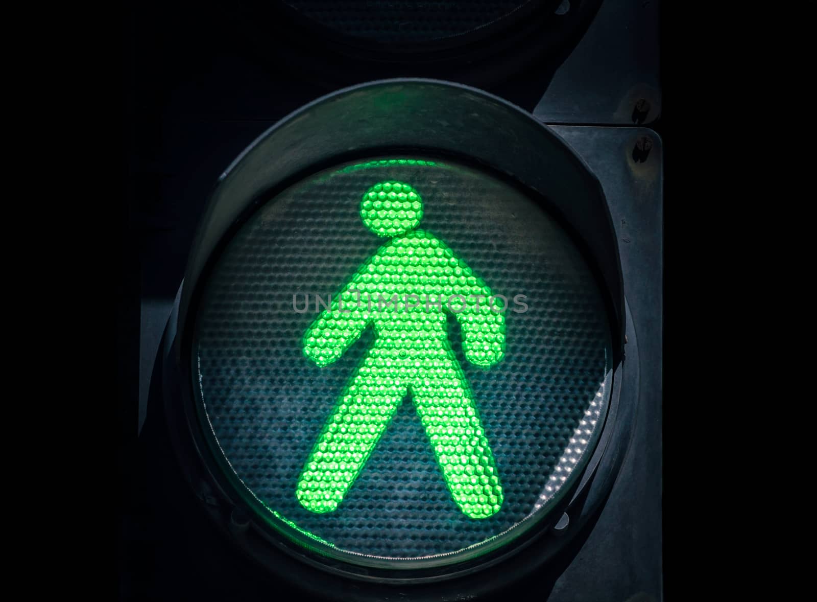 traffic light with green man on a black background abstract urban