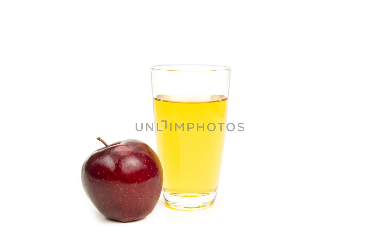 A glass of apple juice, isolated on white background