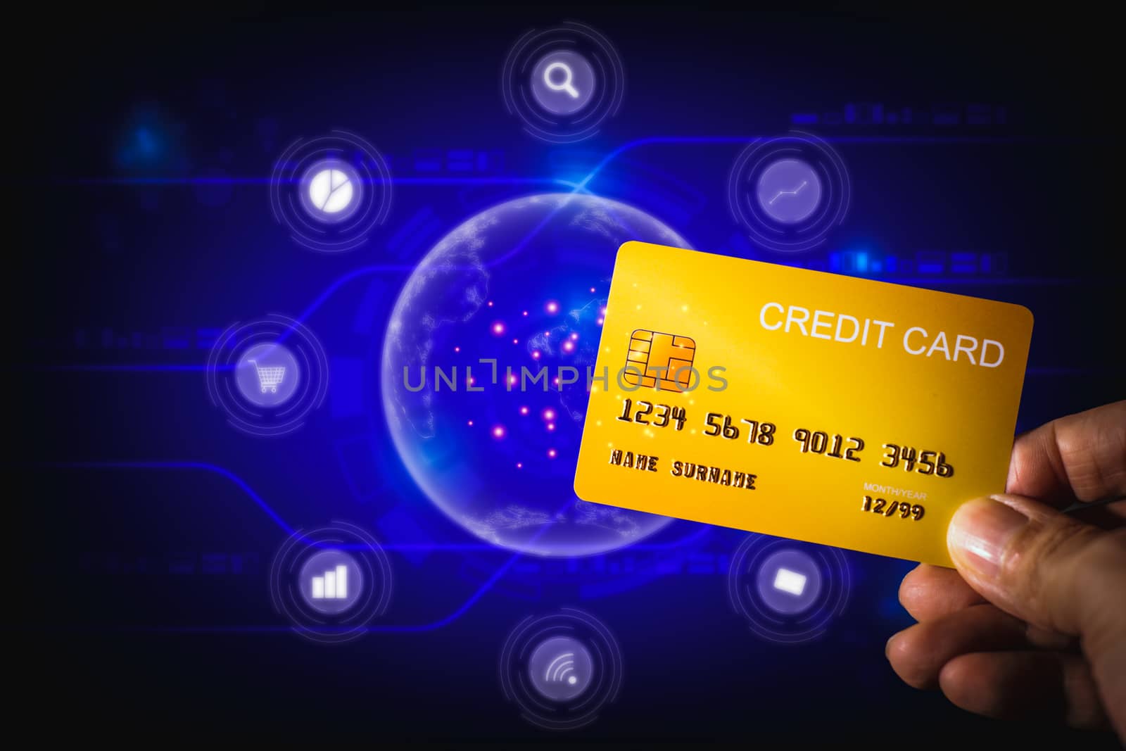 Shopping online concept. Hand holding yellow credit card on blue technology background by iiinuthiii