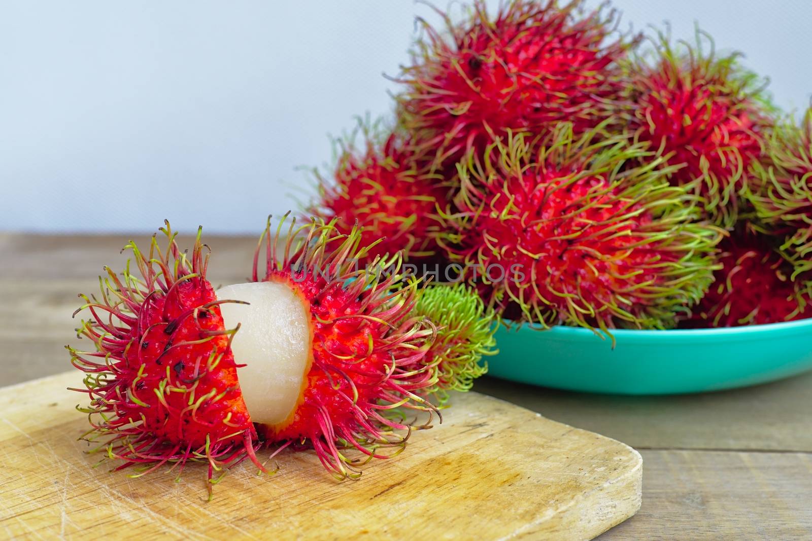 Exotic ripe rambutan fruits from Southeast Asia by Faeldin
