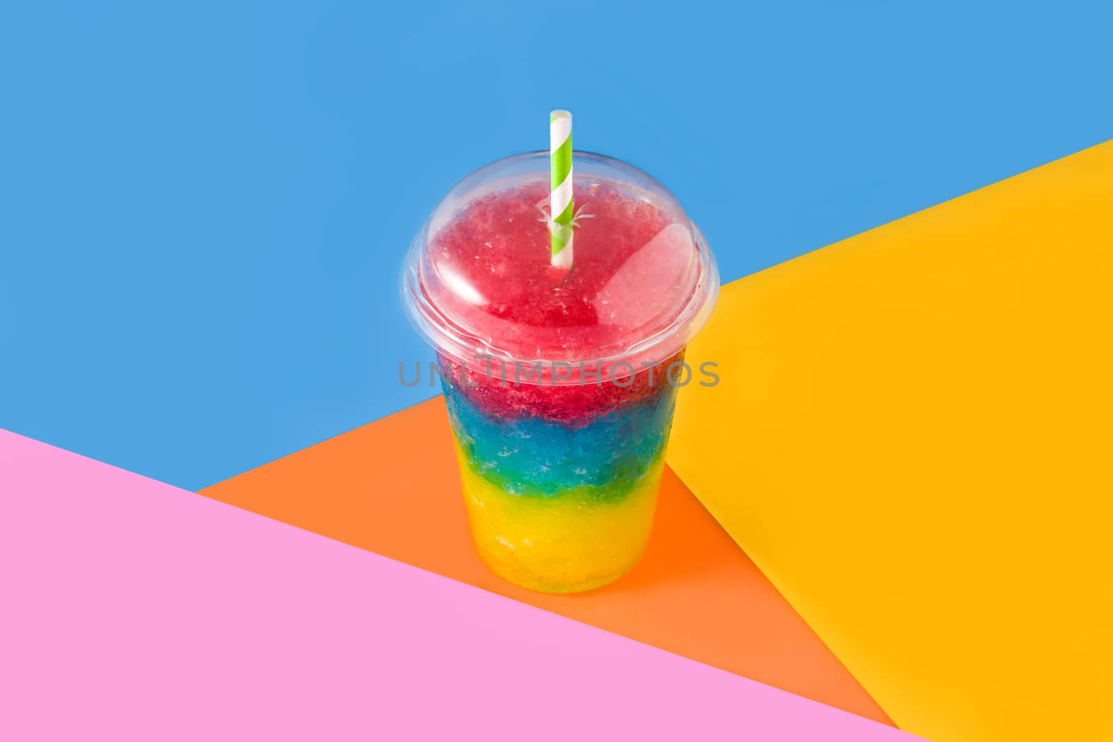 Colorful slushie of differents flavors on colorful background