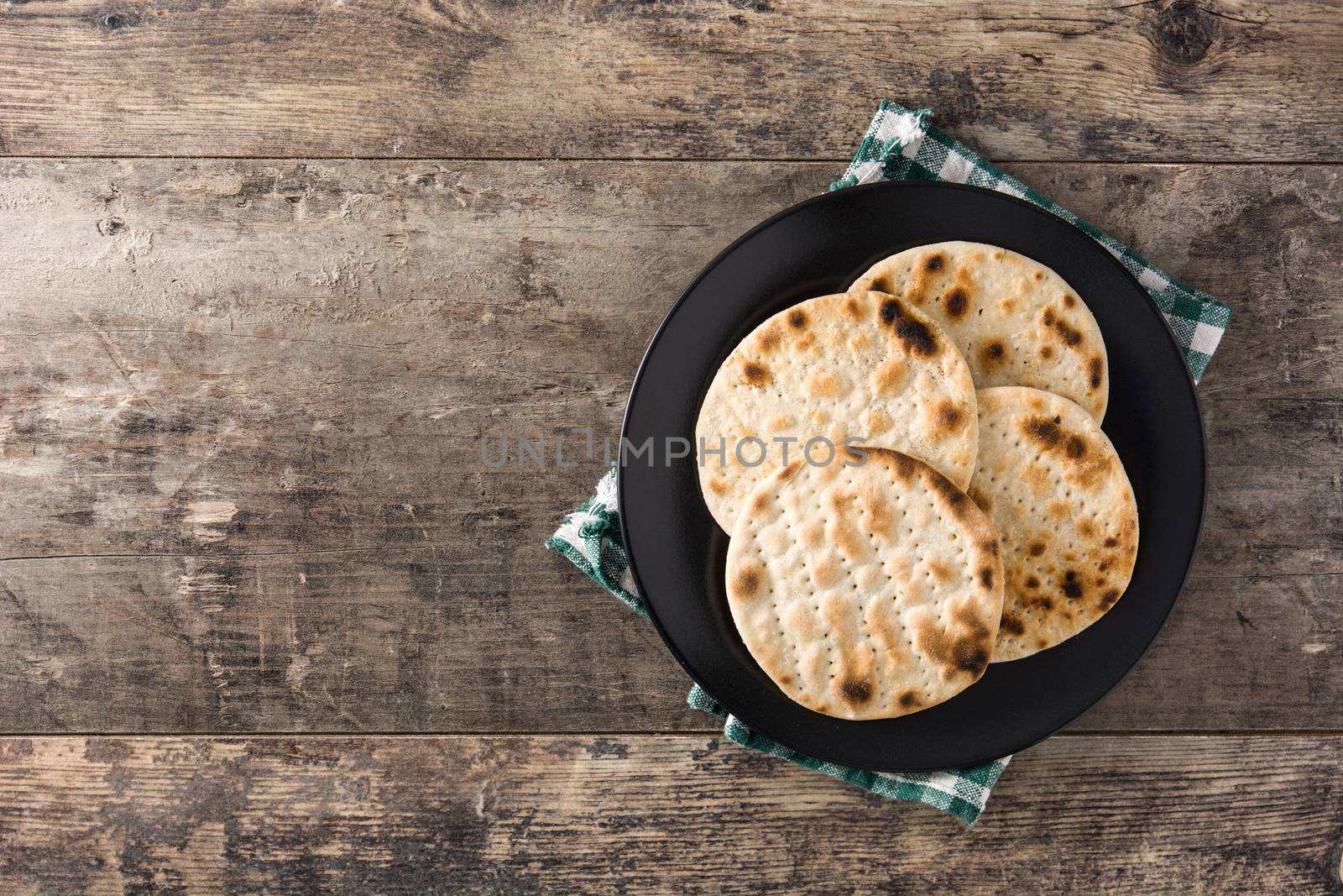 Handmade matzah for Jewish Passover on wooden table