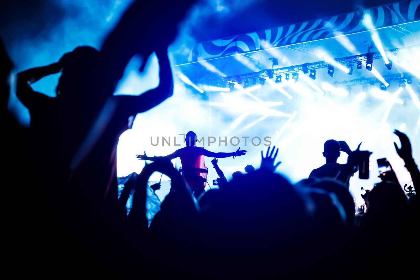 A lot of hands, crowd on concert, blue light