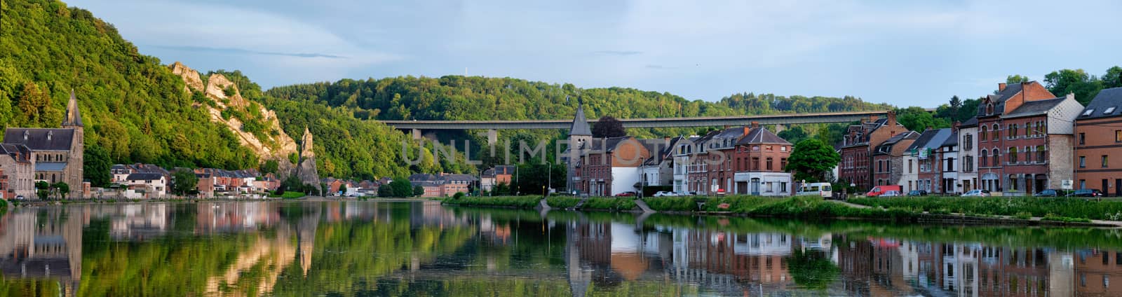 View of picturesque Dinant city over the Meuse river Dinant is a Walloon city and municipality located on the River Meuse, in the Belgian province of Namur on sunset with Bayard Rock and highway