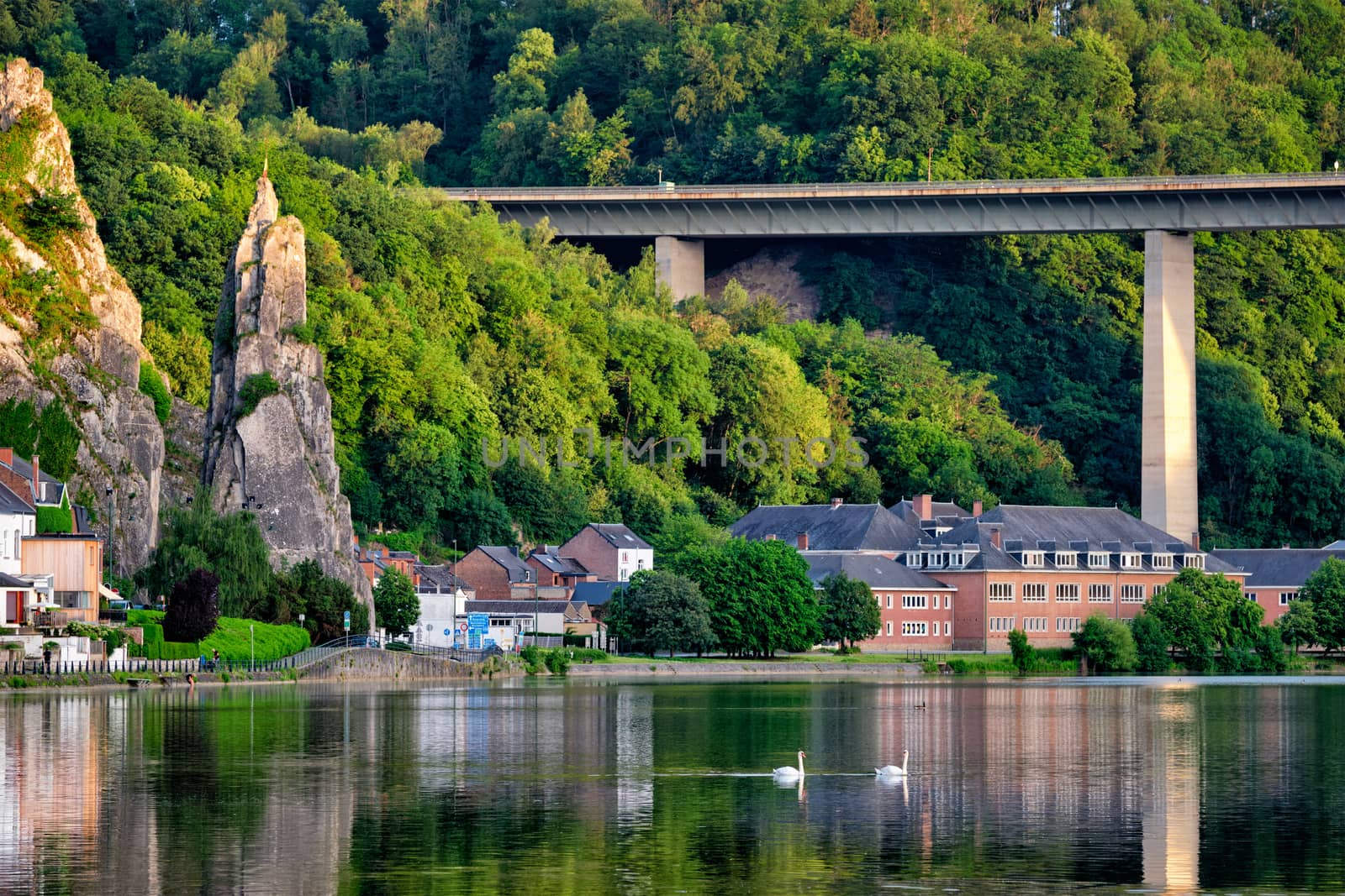 View of picturesque Dinant city over the Meuse river Dinant is a Walloon city and municipality located on the River Meuse, in the Belgian province of Namur on sunset with Bayard Rock and highway