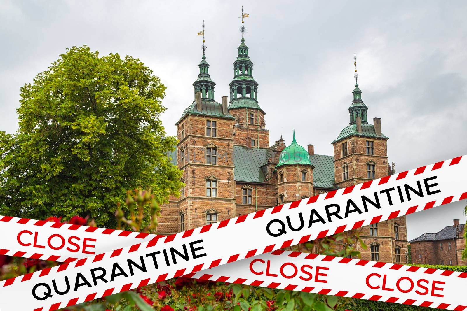 Barrier tape with the words close and quarantine on the background of the Rosenborg Castle. Travel industry crisis, Denmark. Rosenborg Castle is quarantined. Lack of tourists due to pandemic COVID-19