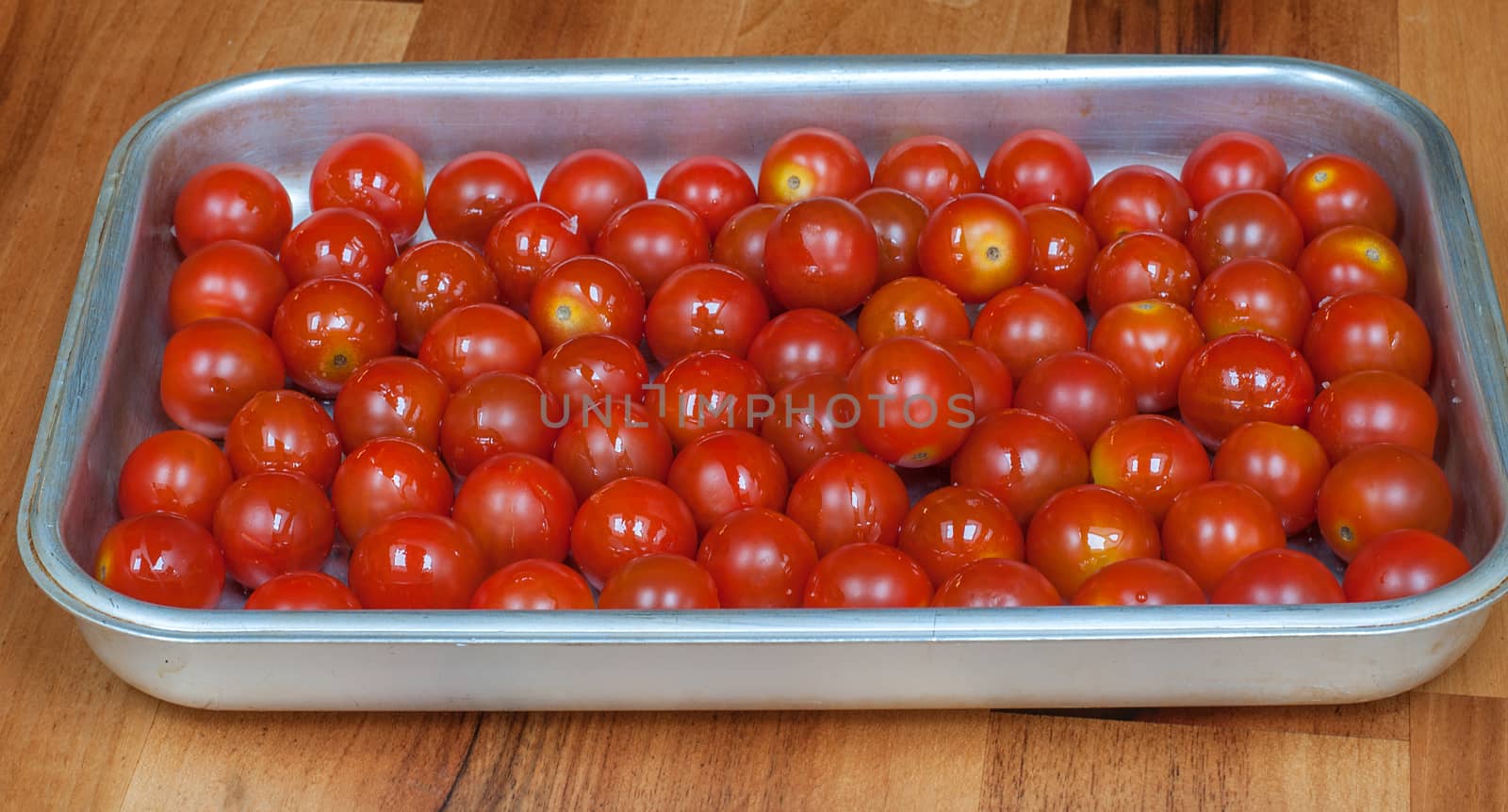 a tray of red cherry tomatoes by sirspread