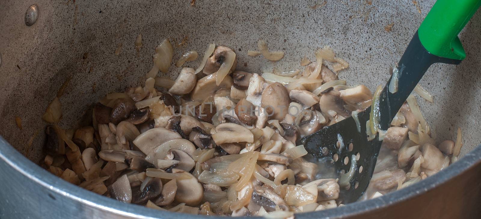 mushrooms and onions cooking in a big steel pan by sirspread