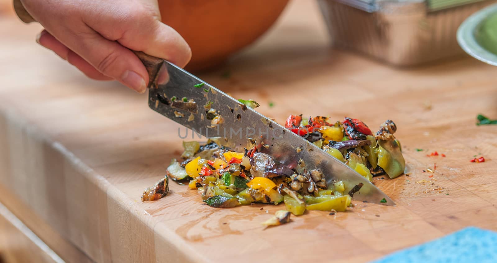 chopped mediterranean vegetables on a wooden block by sirspread