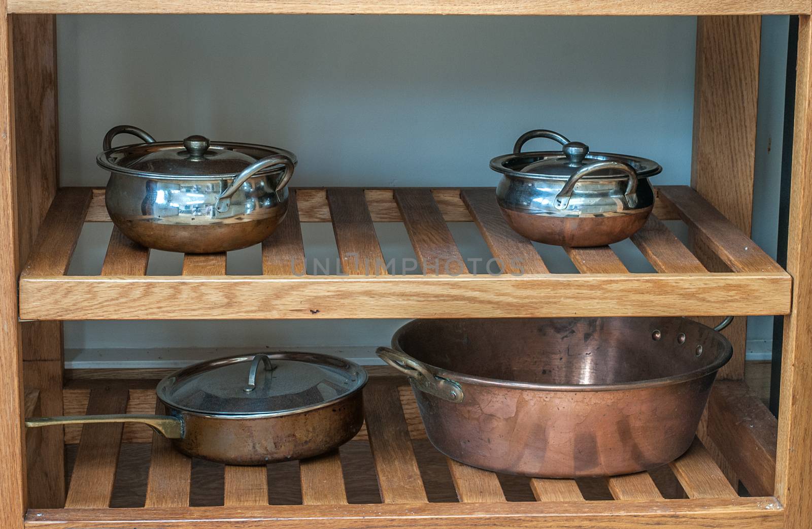 pots and pans on wooden shelves by sirspread