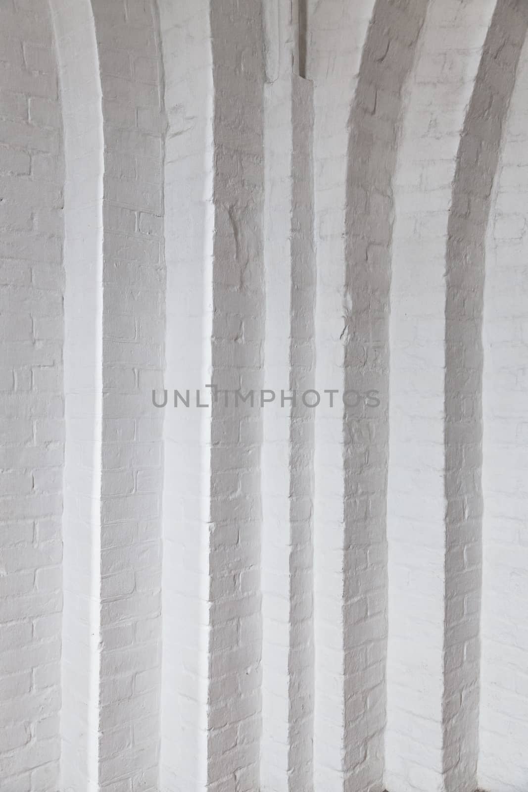 White brick wall with many corners. White room with white brick wall in the Gothic temple. Corner white brick wall texture.