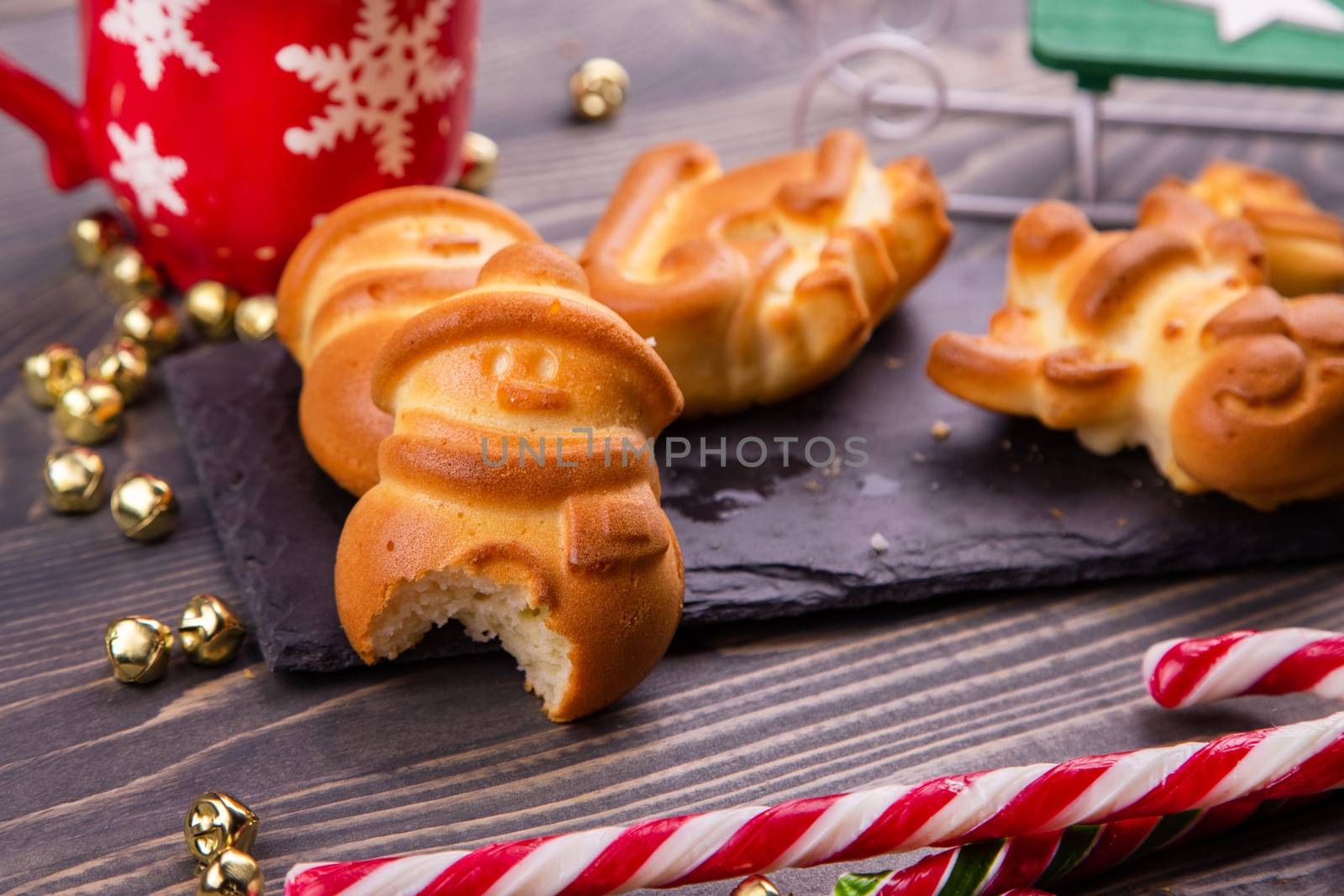 Bitten Christmas gingerbread in the form of a snowman. Children's pranks. Children's holiday New Year. New Year's baking bitten by a child. Christmas background with ruddy gingerbread. Close up.