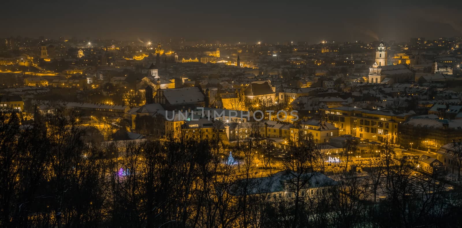 Vilnius Aerial panorama of the Old Town. Vilnius old town panorama at night. Night panorama of the Vilnius Old Town from Hill of Three Crosses, Lithuania. Vilnius winter aerial panorama of Old town.