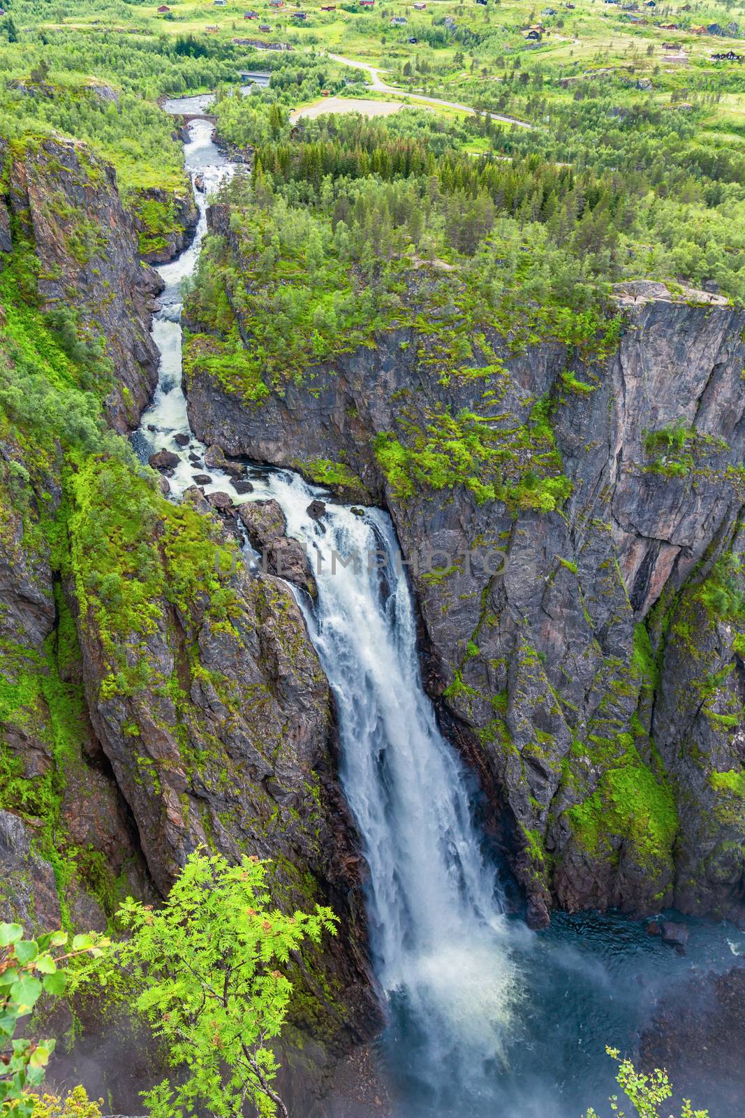 Beautiful top view of the Voringsfossen waterfall. Falls in mountains of Norway. Waterfall Voringfossen - the fourth highest peak in Norway. Tourism holidays and travel.