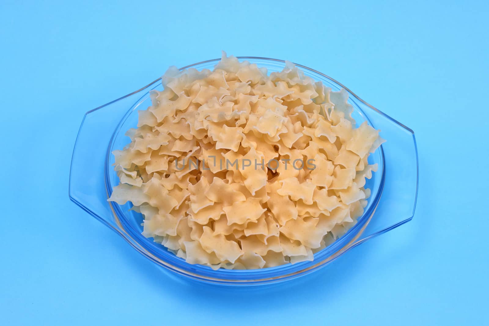Raw pasta in glass dish.
