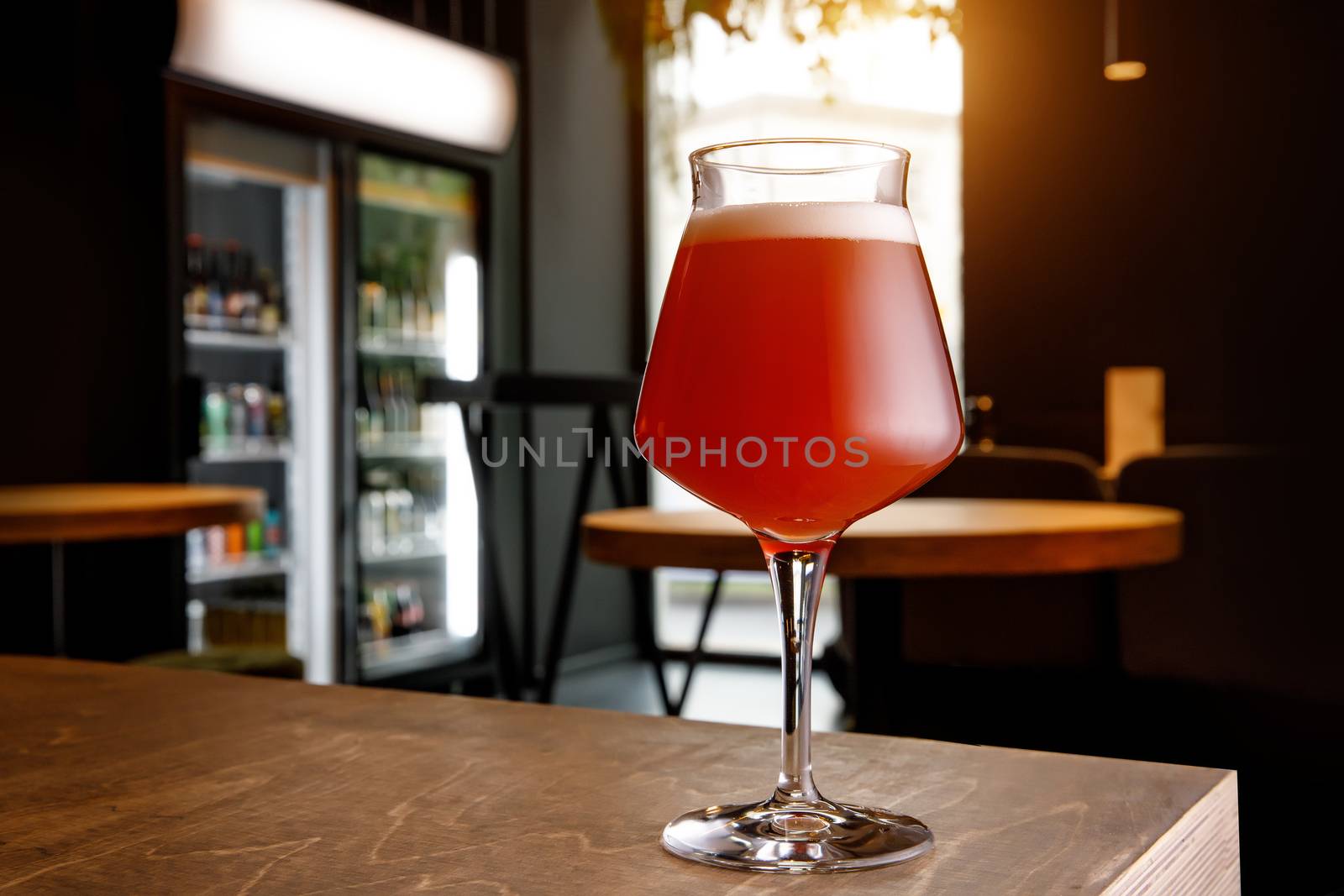 Beer glass in bar interior. Craft in pub. by 9parusnikov