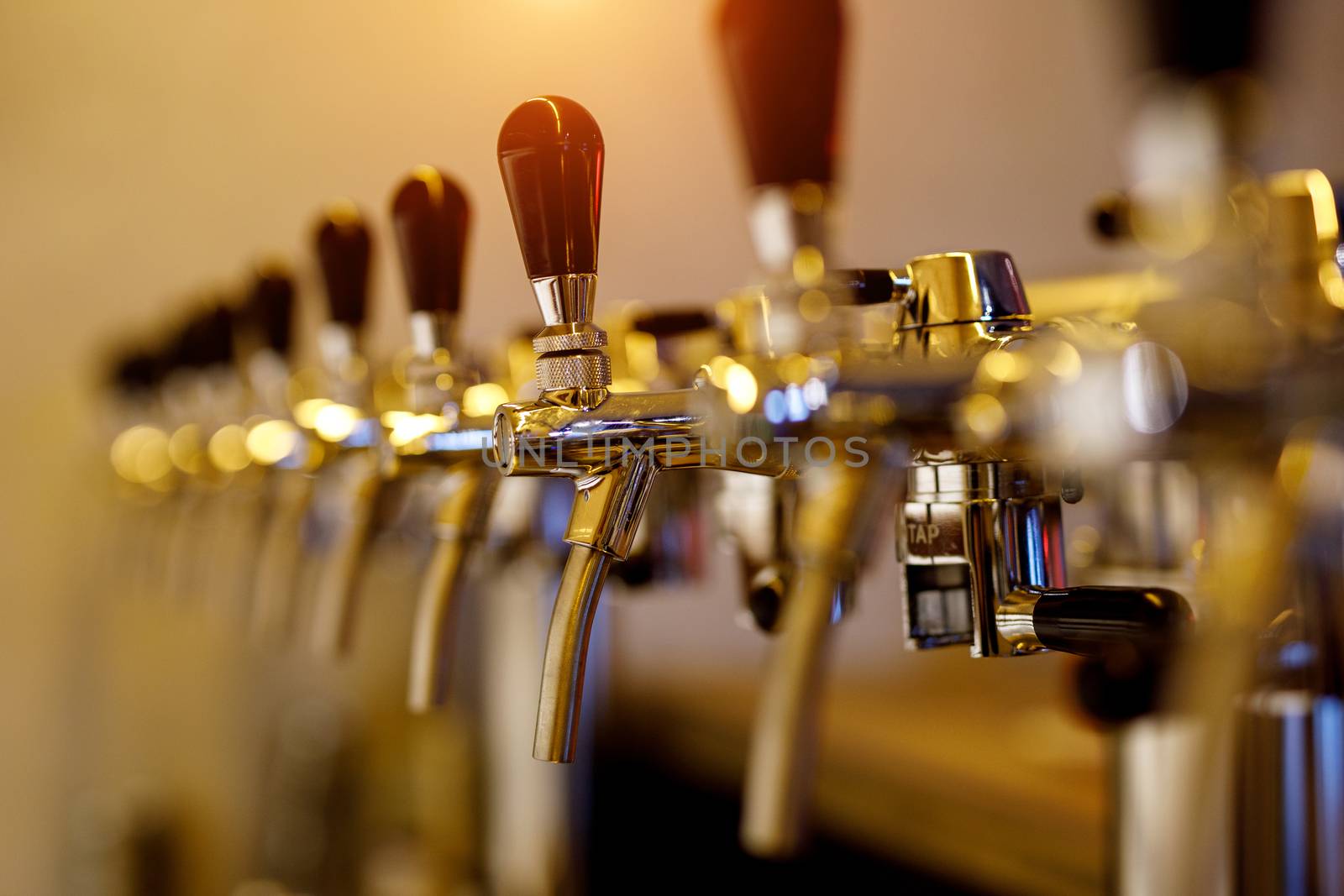 A row of beer taps in a bar by 9parusnikov