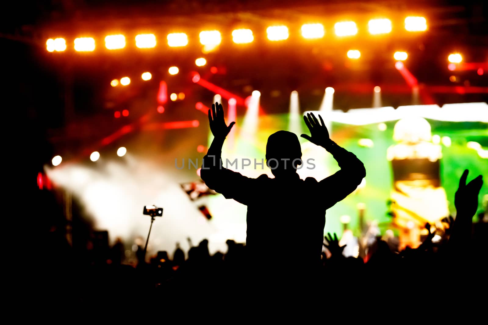 Rock concert, silhouettes of happy people raising up hands. by 9parusnikov