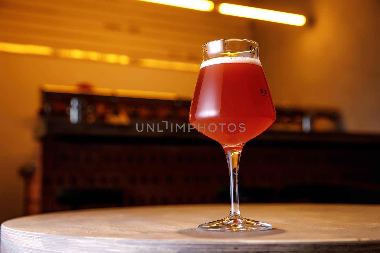 Beer glass in bar interior. Craft in pub