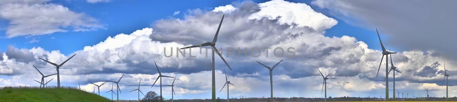 Panoramic view on alternative energy wind mills in a windpark