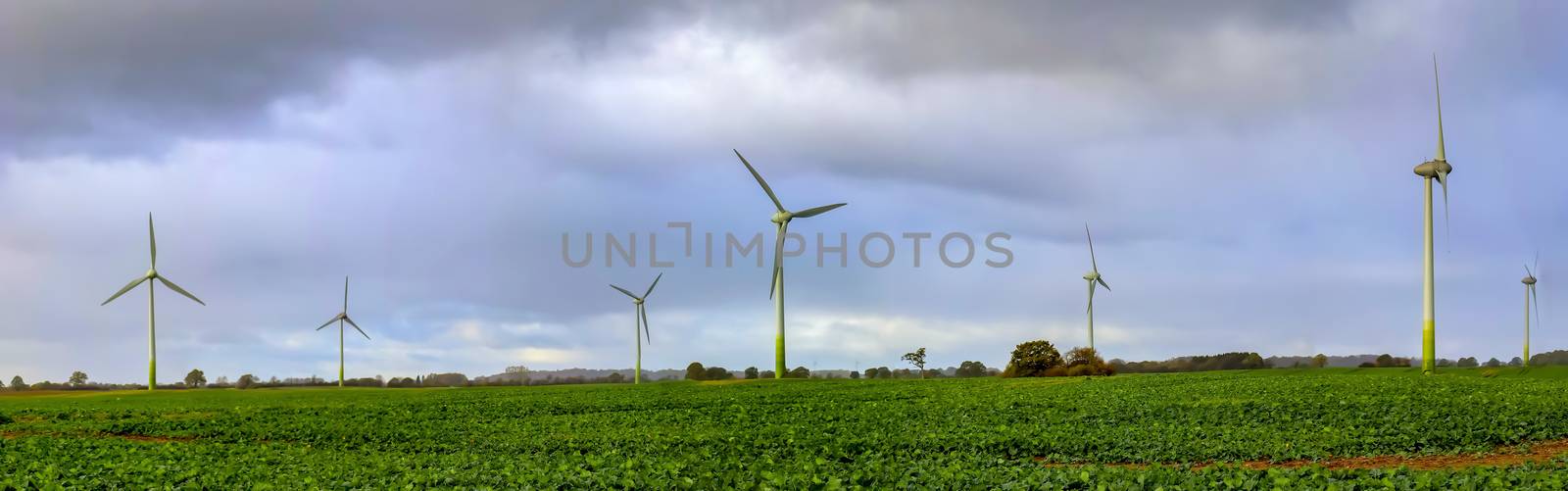 Panoramic view on alternative energy wind mills in a windpark