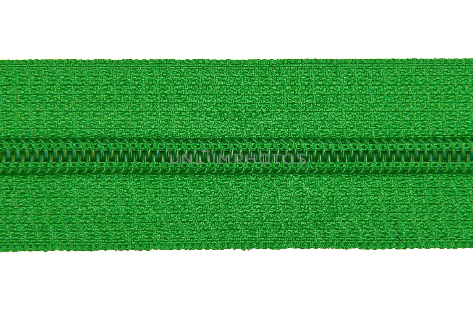 Closed green zipper isolated on white background. Green zipper for tailor sewing. View from above