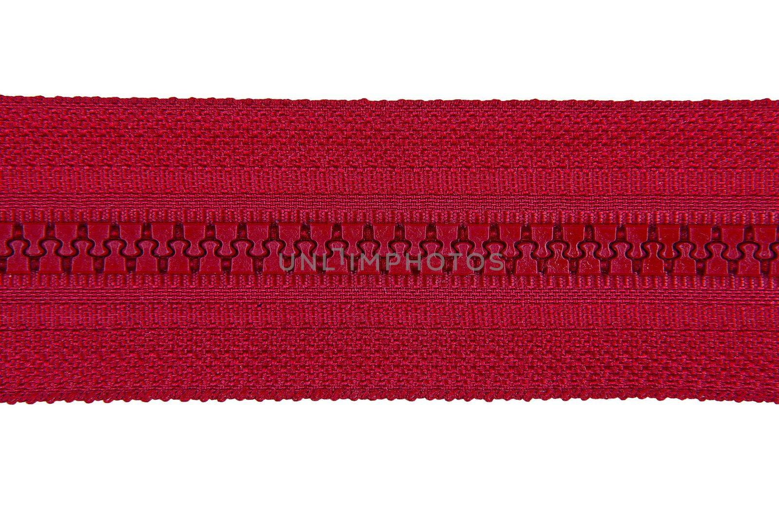 Closed red zipper isolated on white background. Red zipper for tailor sewing. View from above