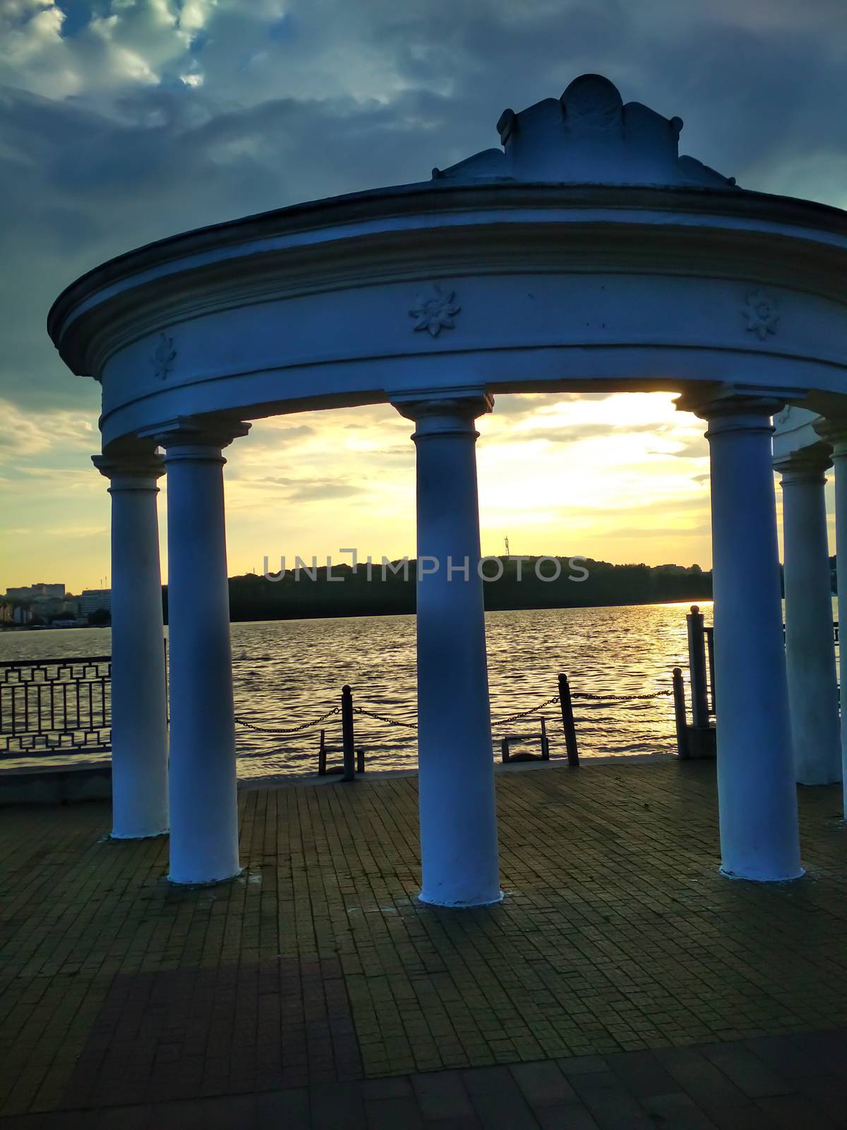 Rotunda on the embankment on a warm evening before sunset. Romance on the quay at the river. Ukraine