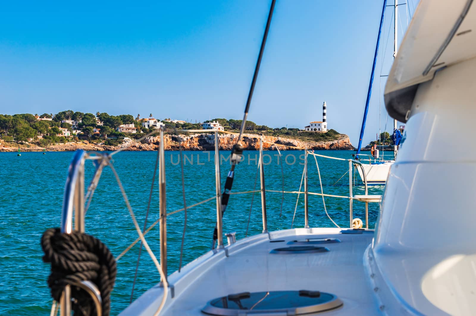 Idyllic view of lighthouse in Porto Colom from marina, Mallorca island, Spain Mediterranean Sea