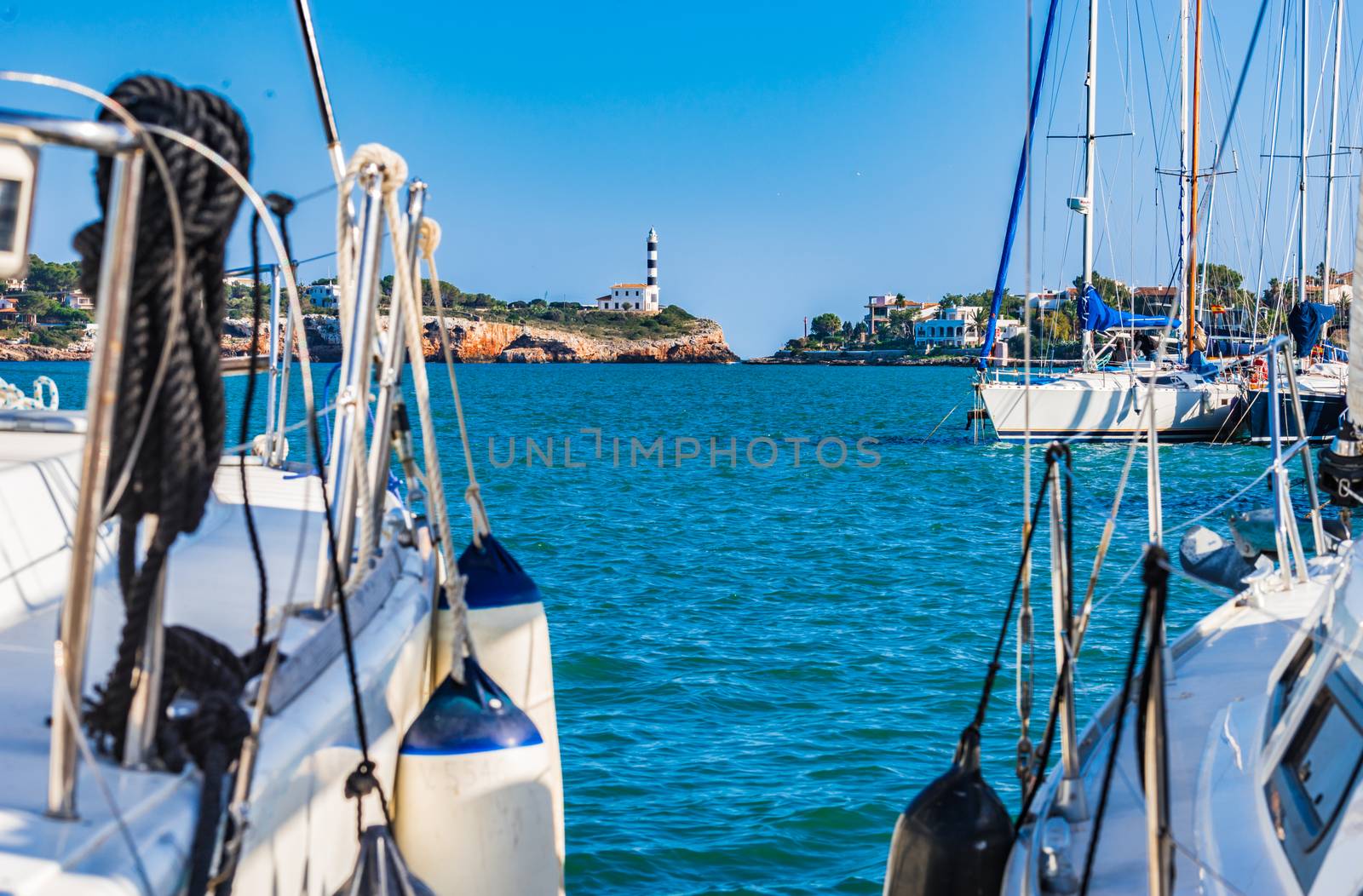 Maritime coast view with yacht and lighthouse in Portocolom on Majorca island, Spain