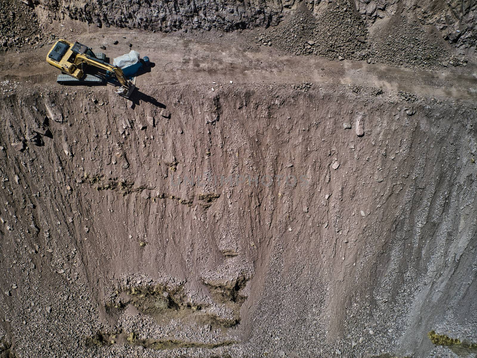 Aerial view of excavator on dangerous high-mountain road in Andes, South America