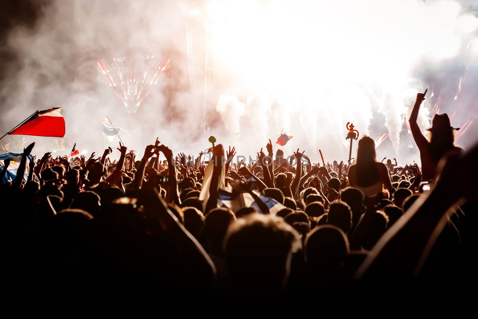 A lot of people with raised hands on a festival music show. by 9parusnikov