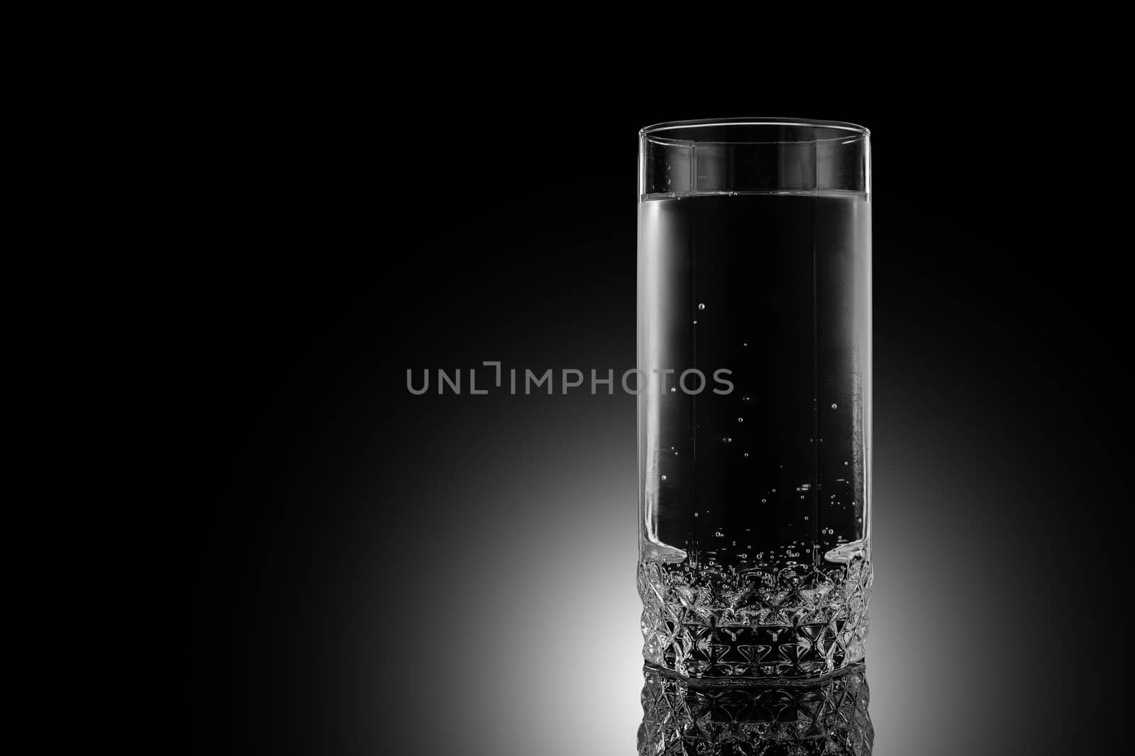 Glass of water on a black background. by 9parusnikov