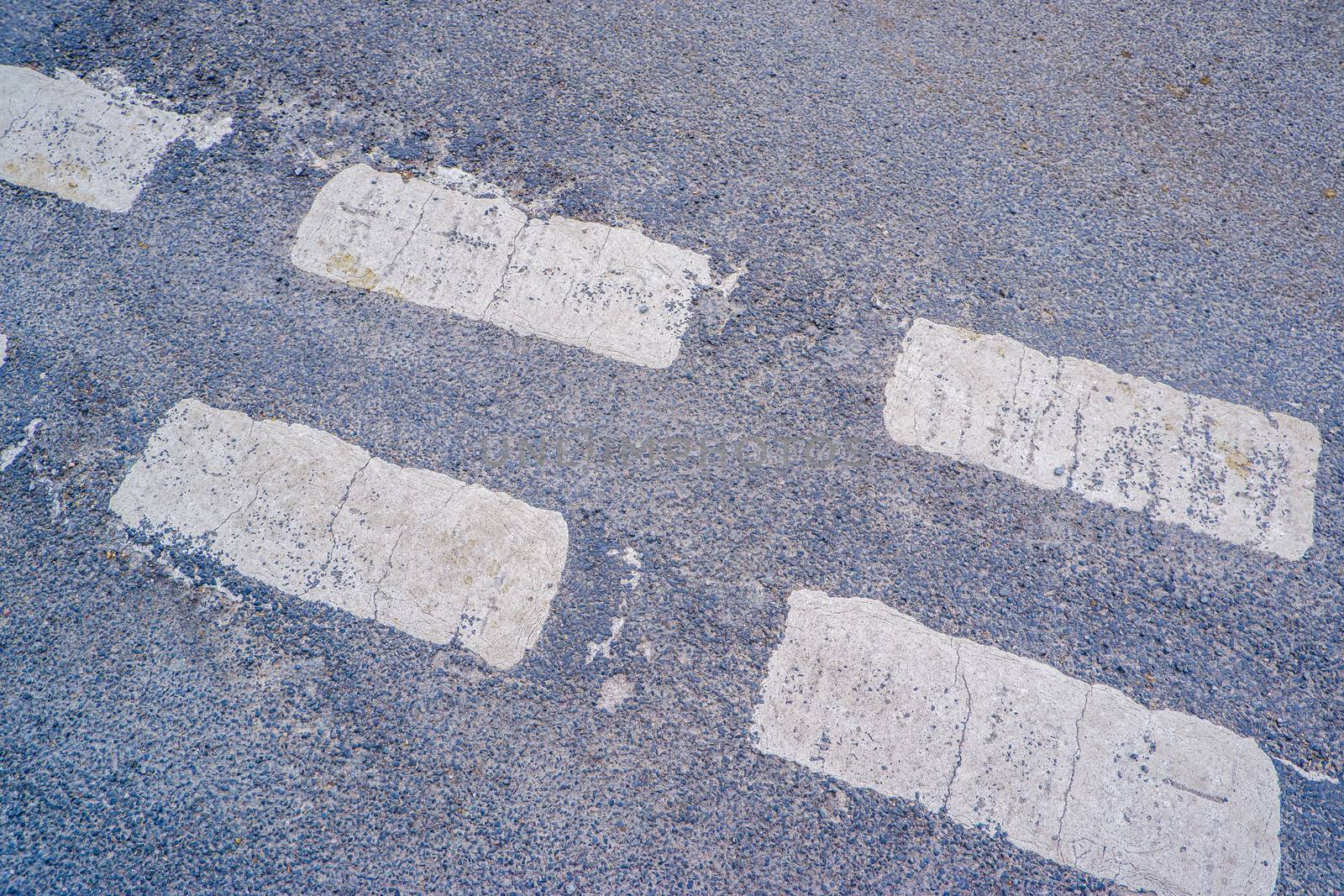 Give way sign on asphalt, detail of a traffic signal by paddythegolfer