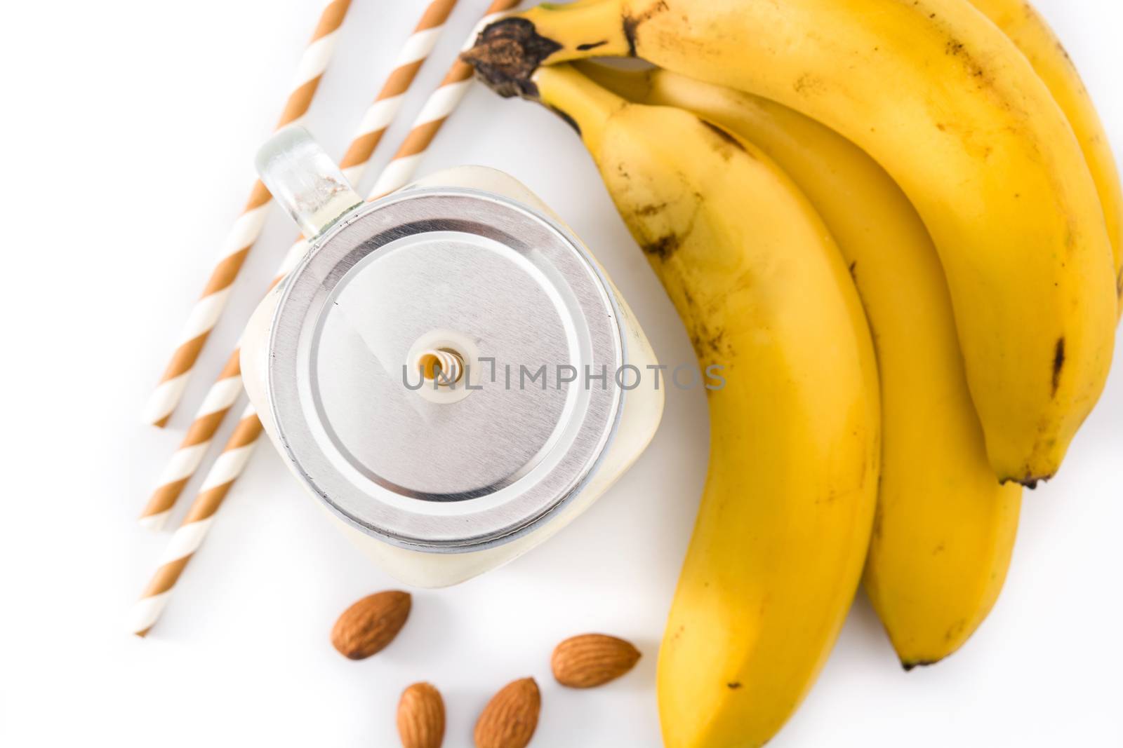 Banana smoothie with almond in jar isolated on white background top view