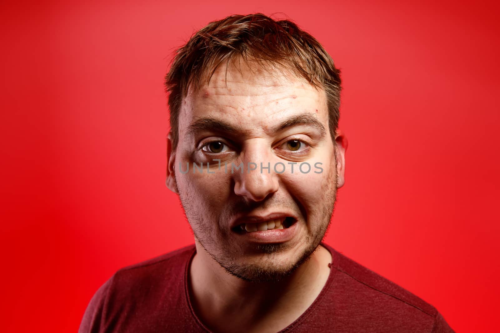 Angry man on a red background