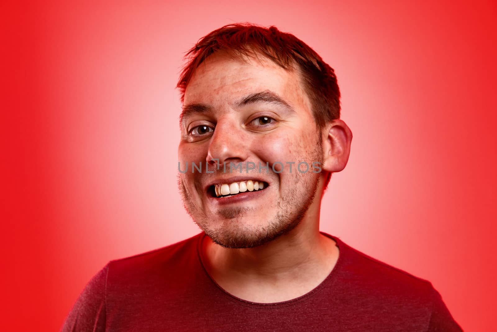 Smiling man on a red background. by 9parusnikov