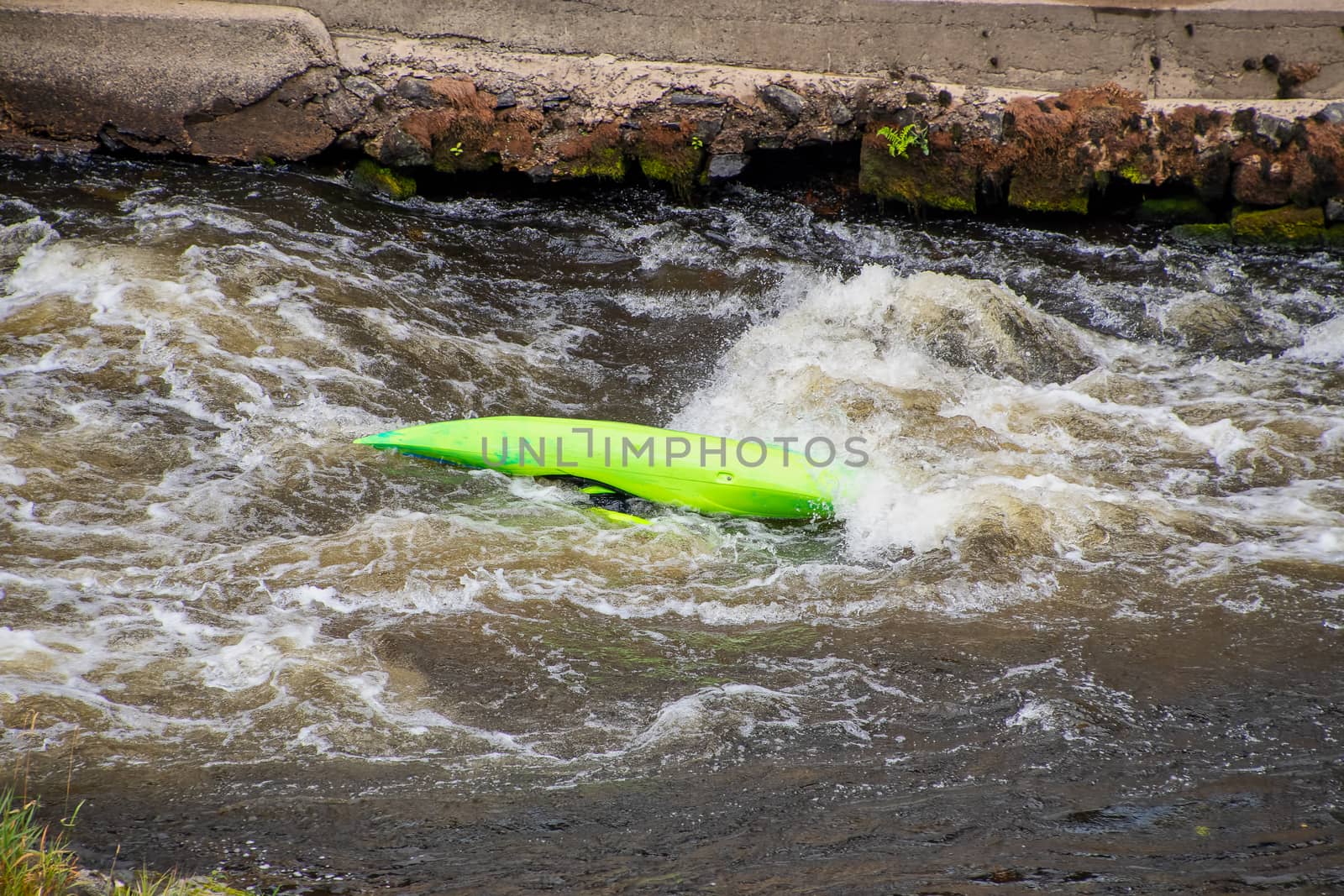 Capsized canoe in white water rapids on the river Dee