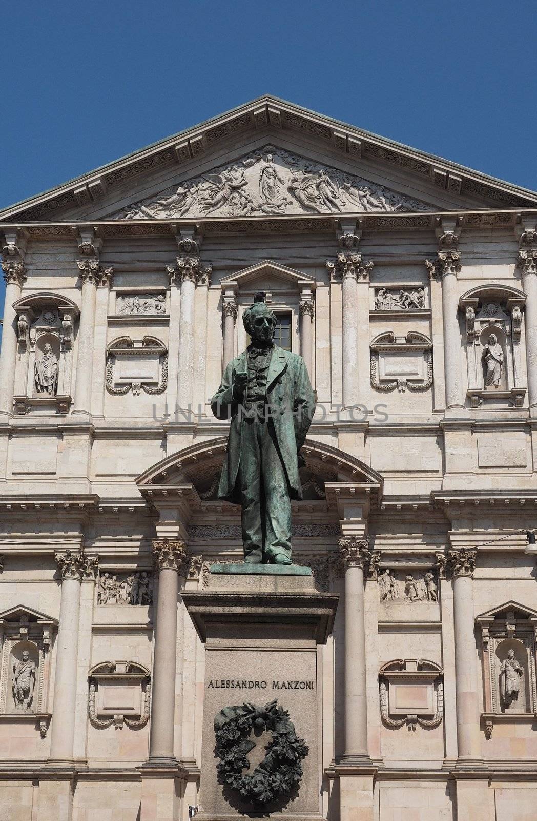 MILAN, ITALY - CIRCA APRIL 2018: Statue of writer Alessandro Manzoni in front of San Fedele church