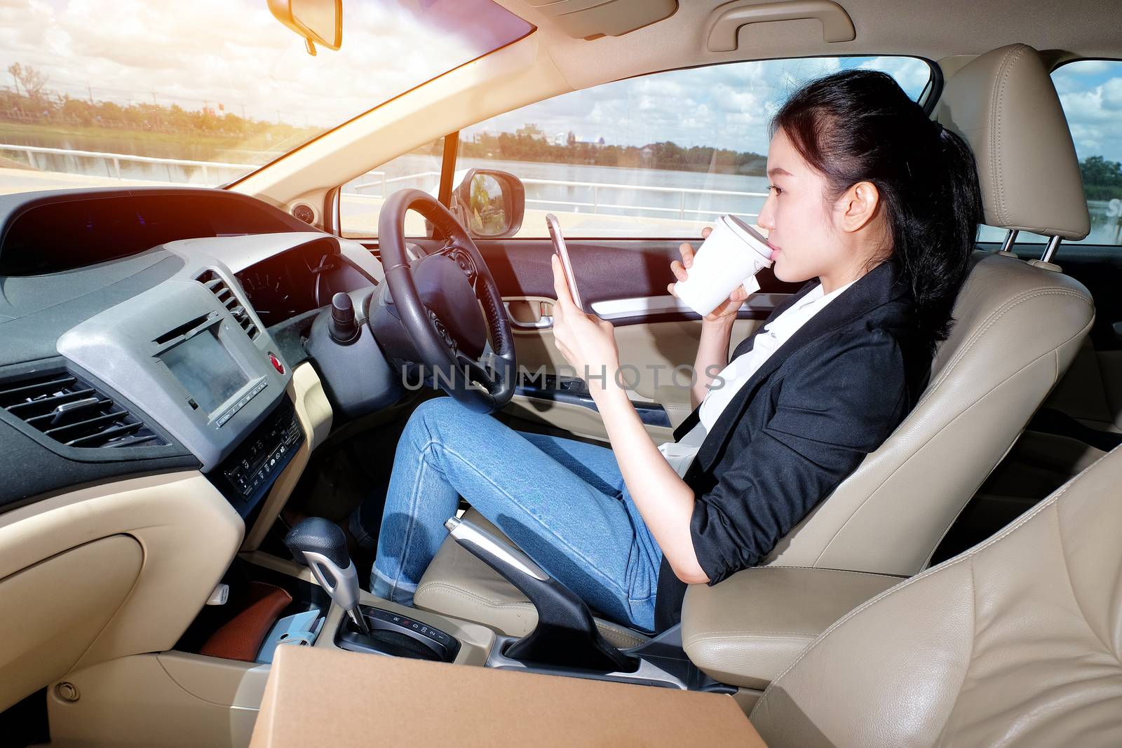 Young Girl Coffee and mobile players. Before going to drive her car.