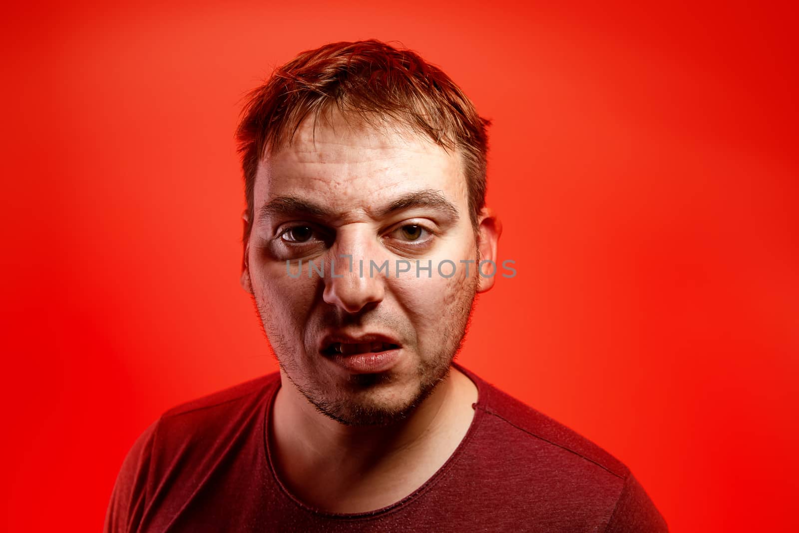 Angry man on a red background. by 9parusnikov