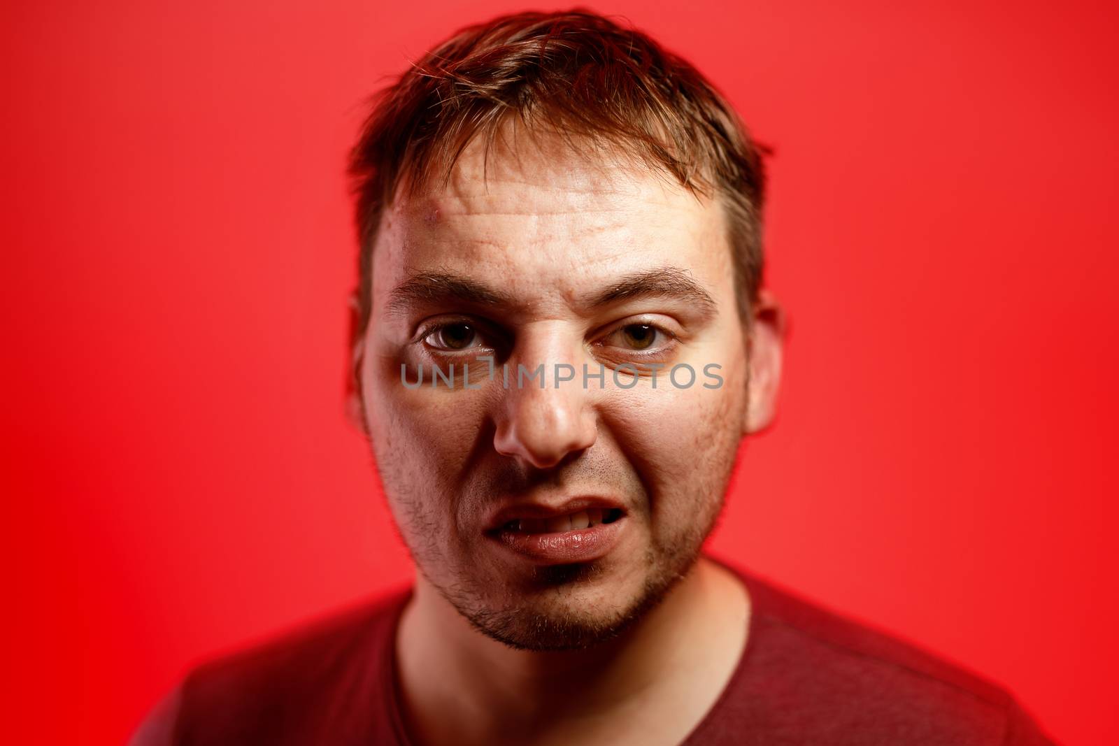 Angry man on a red background