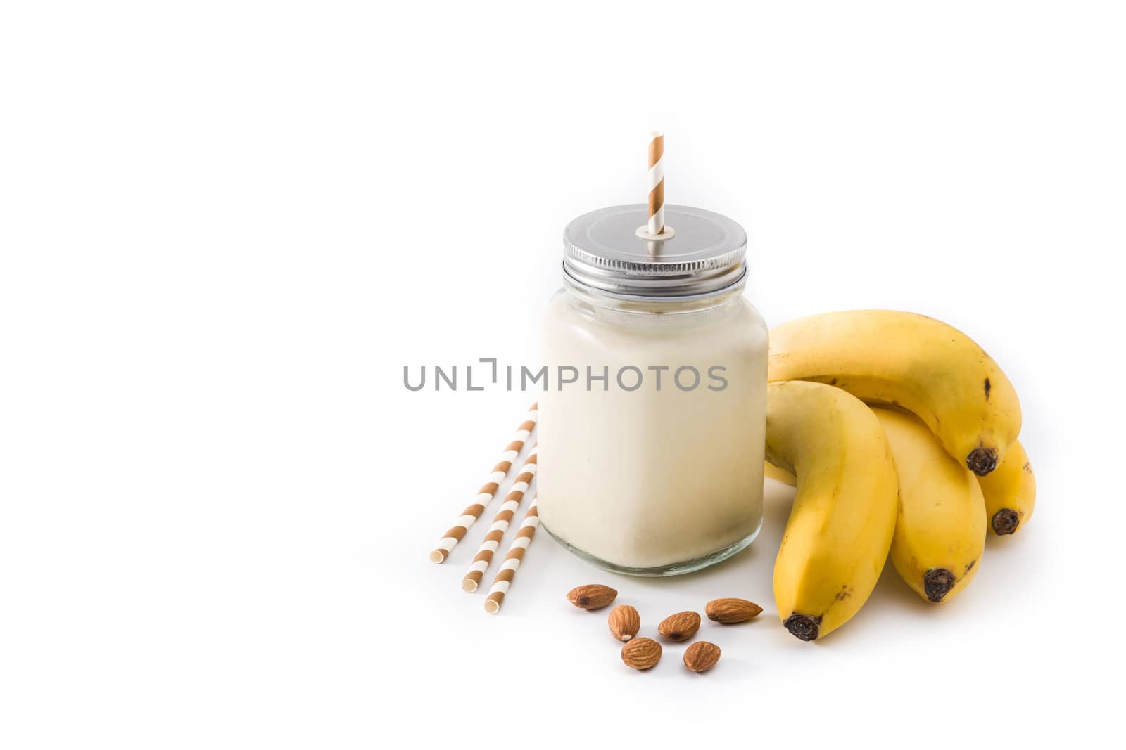 Banana smoothie with almond in jar isolated on white background. Copy space by chandlervid85