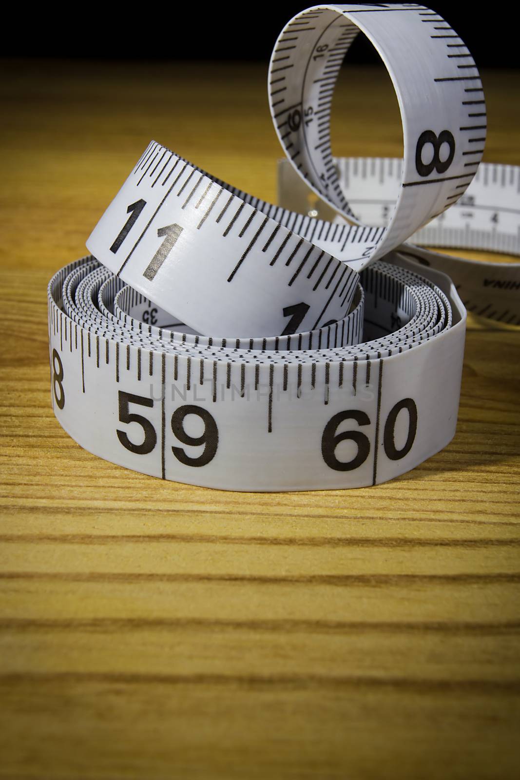 White tailor meter on a wooden table