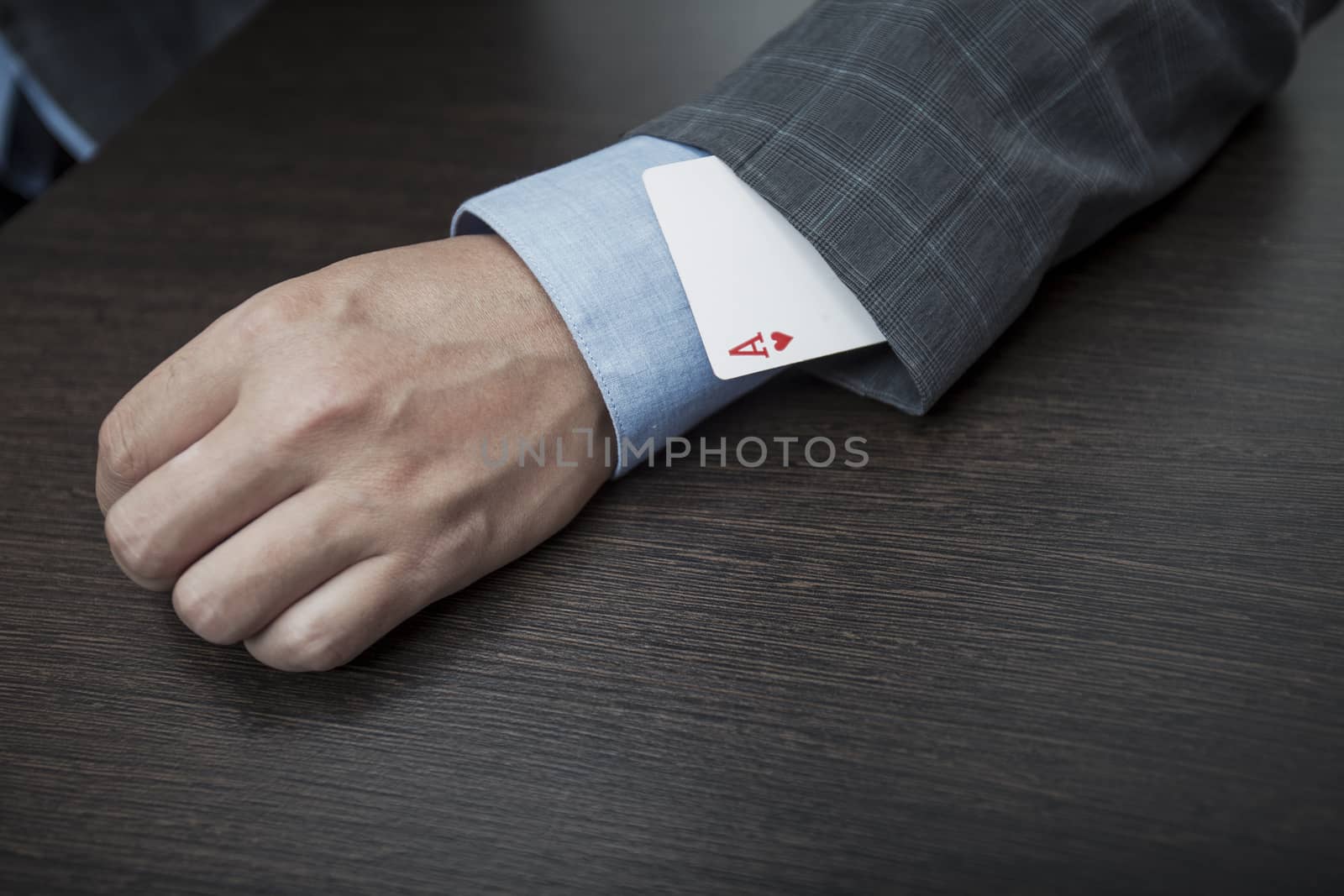 Man's hands close up, hide an ace in a sleeve